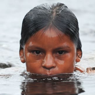 A kid's head sticking out of the water