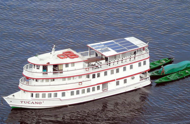 A boat with solar panels on top deck