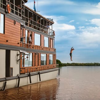 A man jumping to the river from the Delfin II