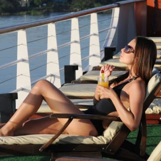 A woman sunbathing on the deck