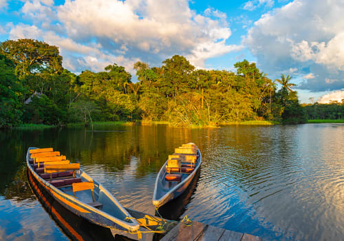 Two,Traditional,Wooden,Canoes,At,Sunset,In,The,Amazon,River